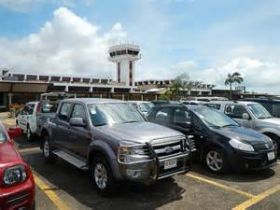 Cars in parking lot of Belize International Airport – Best Places In The World To Retire – International Living